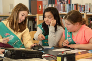 Girl scouts practicing Morse code