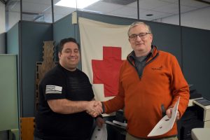 Photo of Paul Gayet, AA1SU shaking hands with American Red Cross representative following MOU signing